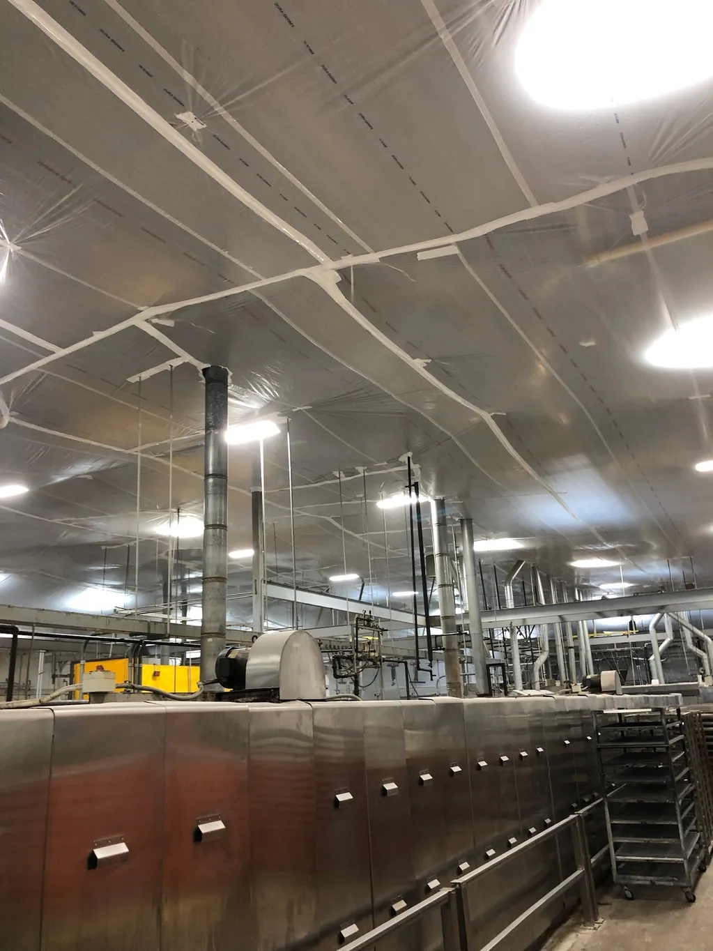 A manufacturing factory with temporary suspended ceiling covers