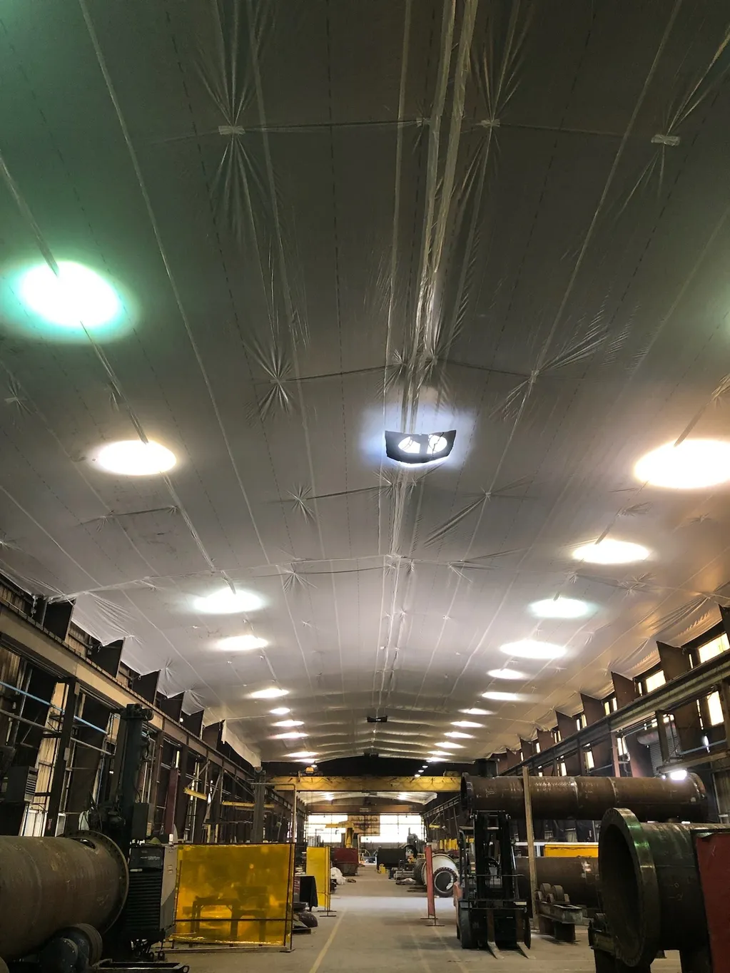 Temporary suspended ceiling covers inside a warehouse