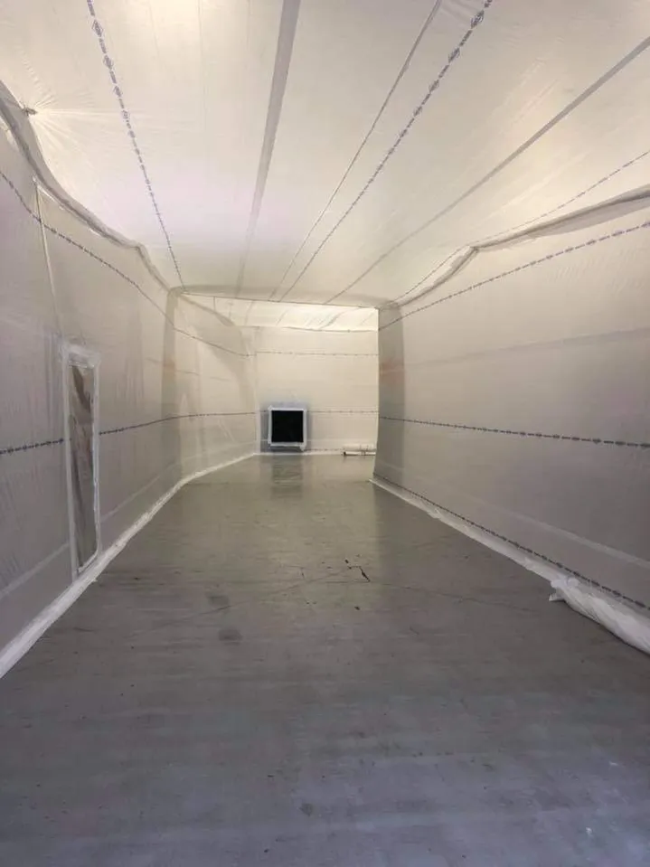 A hallway covered by temporary walls