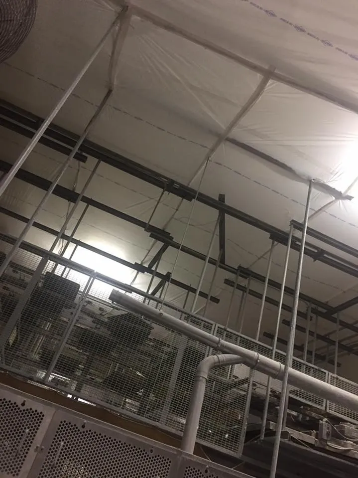 Metal popes and tubes near temporary suspended ceiling covers